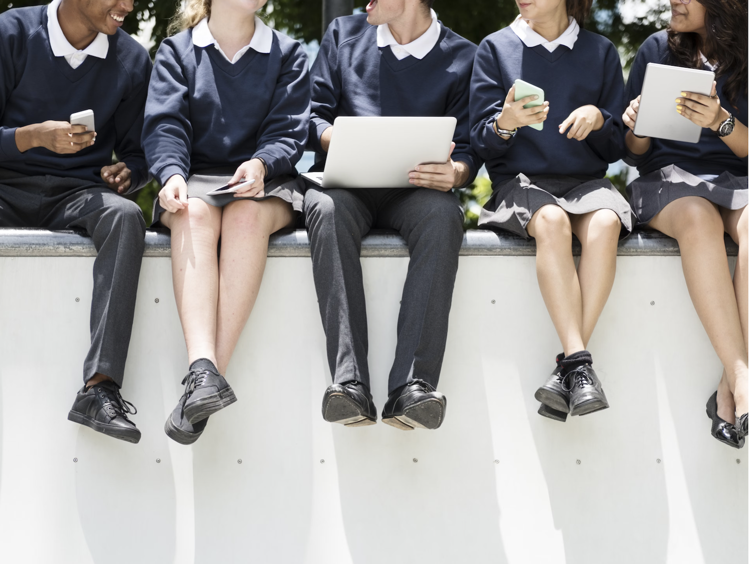Students sitting on wall together education school teenagers